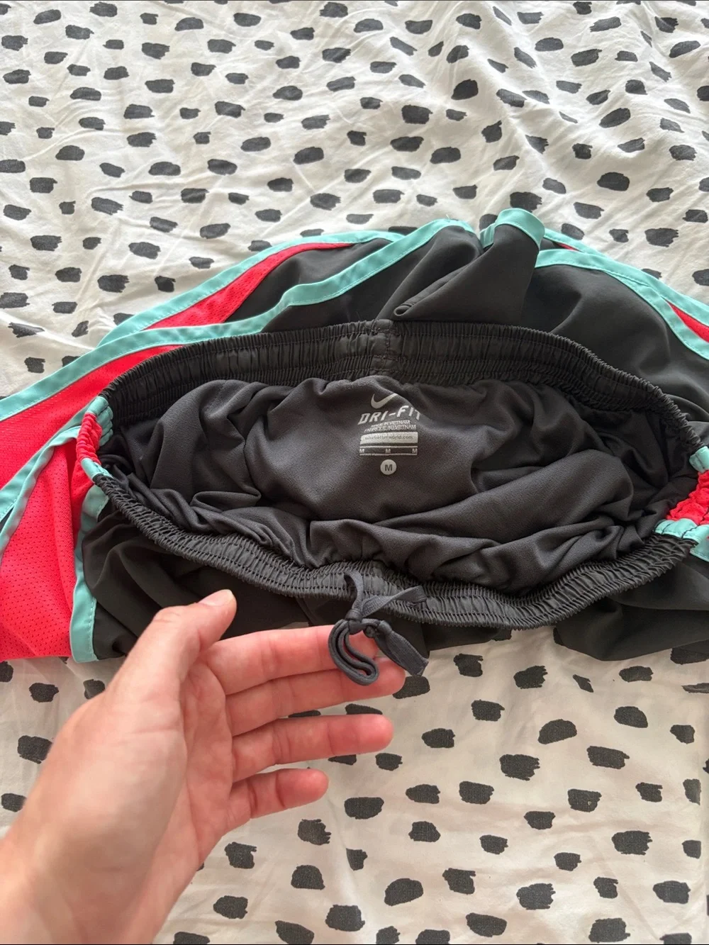 Nike Black Athletic Shorts with Teal Trim and Coral Side Panels